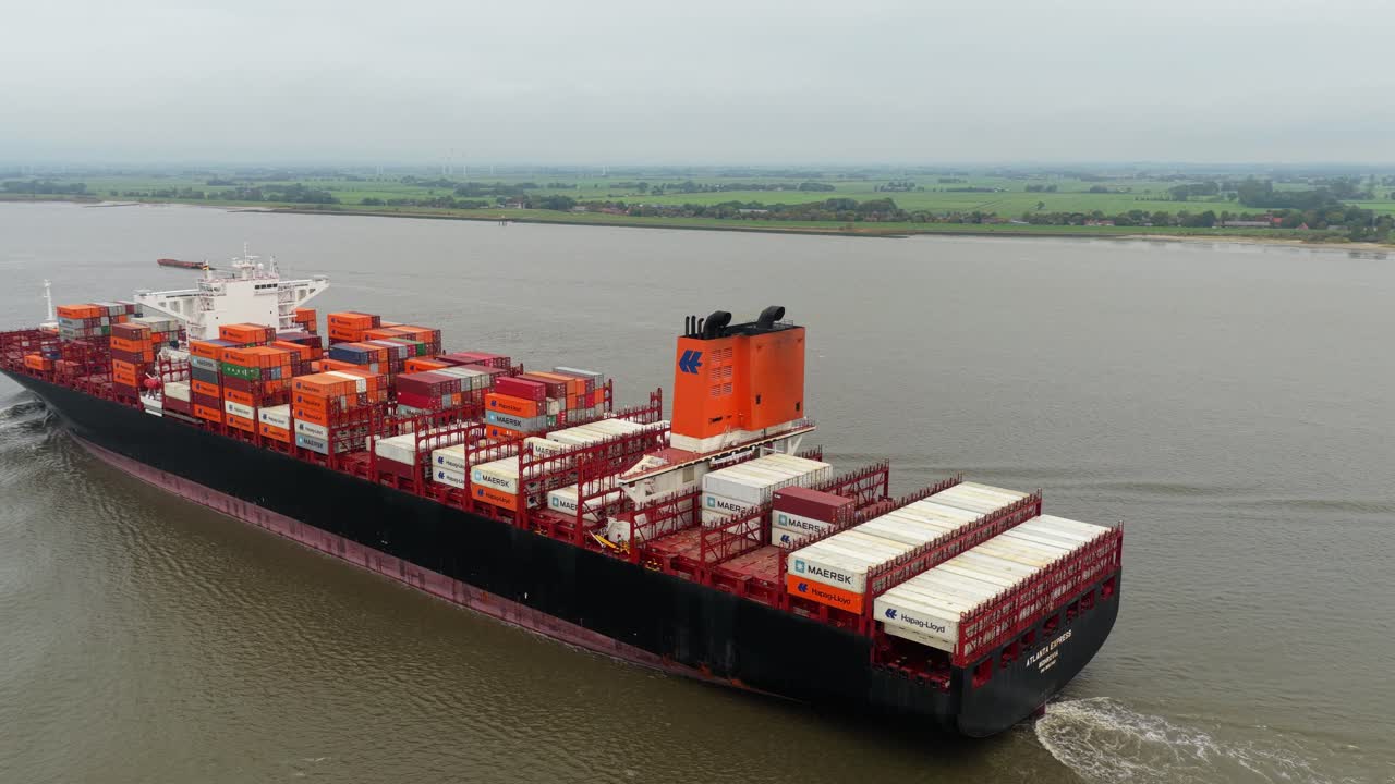 High angle view of transport ship cruising with containers on river