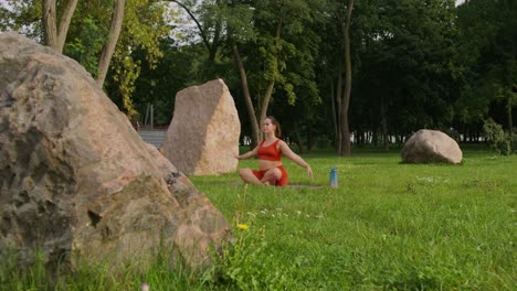 woman practicing yoga in a park