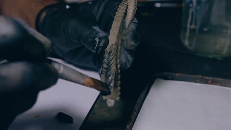 painting-workshop-man-painting-3d-printed-horns-with-a-brush-slow-motion-close-up-shot