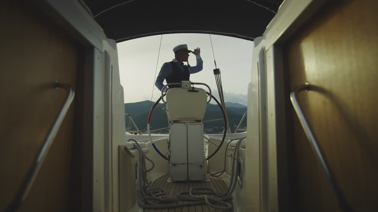 Sailor at the Helm of a Yacht