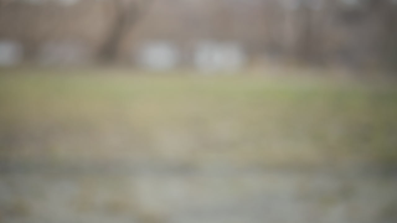 Close-up of handshake between two people outdoors, one wearing dark textured hoodie and other in pink winter jacket, symbolizing greeting, agreement, cooperation, friendship on cool day in park