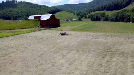 aerial orbit of hay being raked in sugar grove nc, north carolina near boone and blowing rock nc, north carolina