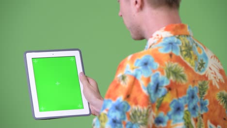 young handsome tourist man using digital tablet