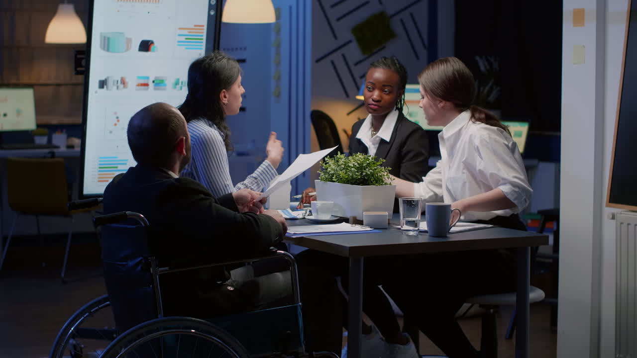 Businesswoman talking to man with digital tablet about project