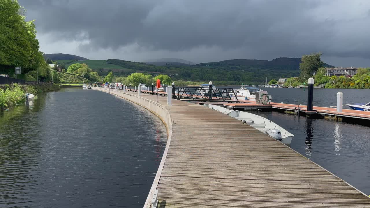 Dark heavy clouds over sunny marina dock on River Shannon in Ireland