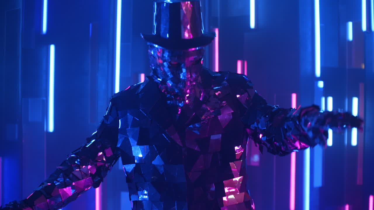 A silver dancing man in a glittering metal suit dances.