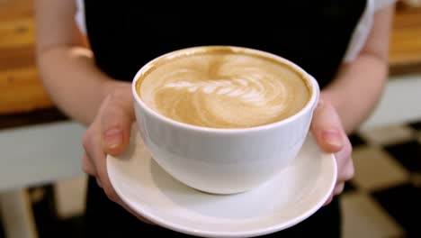 waitress holding cup of coffee