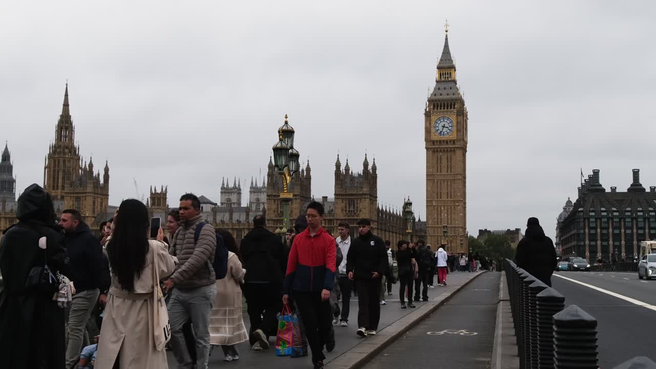 Tourists visit and look at Westminster Parliament building with the Big Ben clock in London, United Kingdom.