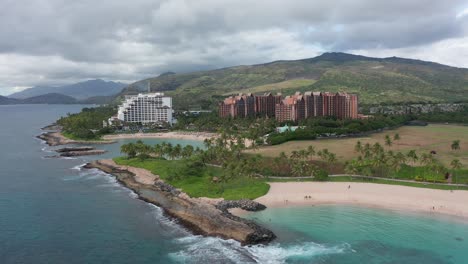 Toma-Aérea-Con-Plataforma-Rodante-A-Lo-Largo-De-Lagunas-Costeras-Con-Complejos-Turísticos-De-Lujo-Al-Fondo-En-La-Isla-De-O&#39;ahu,-Hawai