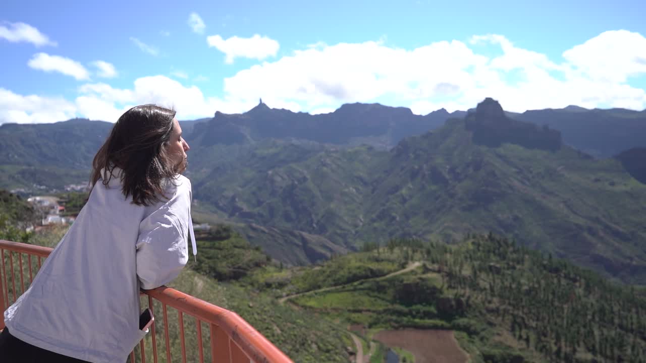 Woman looking at mountains landscape at viewpoint in Artenara, Gran Canaria, Spain