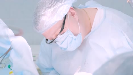 a surgeon in a sterile operating room performing a surgical procedure with focus and precision. represents healthcare, surgery, medical expertise, and patient care