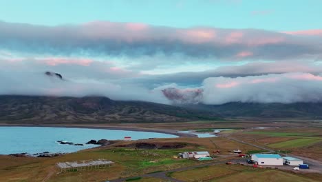 clouds and sunset over mountains in borgarfjordur eystri, iceland - aerial drone shot