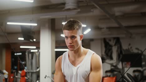 man working out on a cable machine in a gym