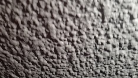 Slow-motion-texture-of-concrete-sludge-plaster-moving-down,-very-cool-effect-for-overlay-or-transitions