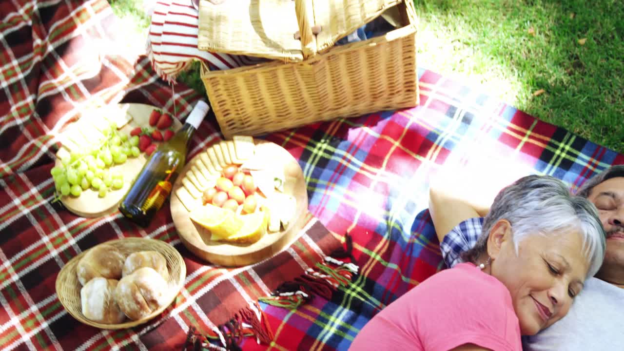 pareja de ancianos acostados en una manta