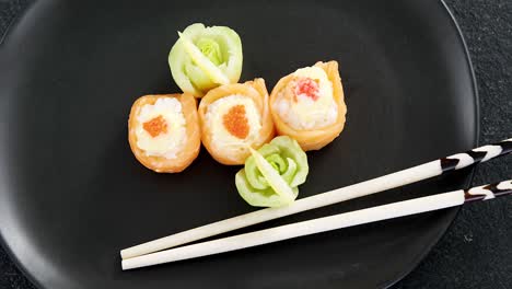 Sushi-served-on-plate-with-chopsticks