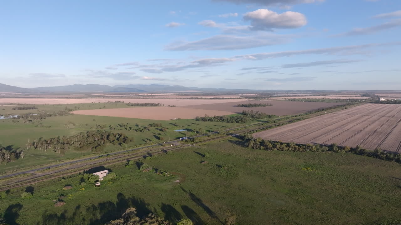 Drone shot of The Newell highway cutting through the vast farming landscape between Moree and Gunnedah, New South Wales, Australia