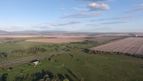 drone shot of the newell highway cutting through the vast farming landscape between moree and gunnedah, new south wales, australia