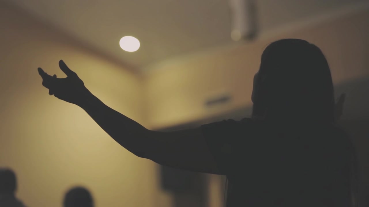 Silhouette of Person Raising Hands in Worship or Prayer