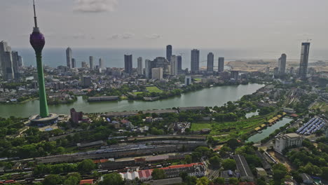 Colombo-Sri-Lanka-Aerial-v6-drone-flyover-Area-10-capturing-downtown-cityscape-across-central-neighborhoods,-main-station-train-yard-and-Lotus-tower-at-Beira-lake---Shot-with-Mavic-3-Cine---April-2023