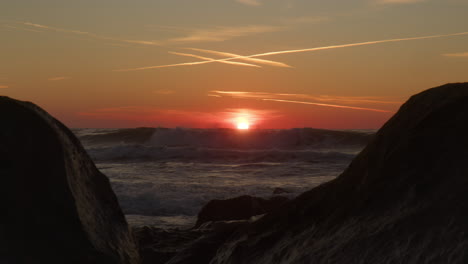 powerful sea waves and sunset in background