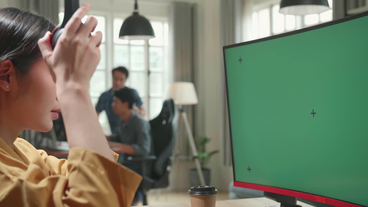 Asian Female Start Works With Mock Up Green Screen Computer Display In Office