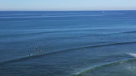 Drone-shot-panning-of-surfers-surfing-on-a-beautiful-winter-day-in-Southern-California