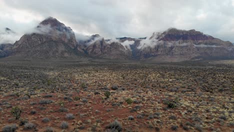 Aerial-drone-shot-of-mountains-with-low-winter-clouds