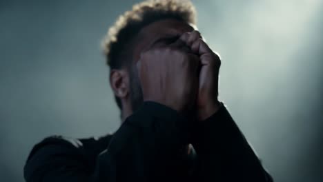 man in distress with hands covering face