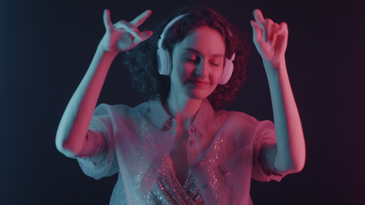 Woman enjoying music in neon lights