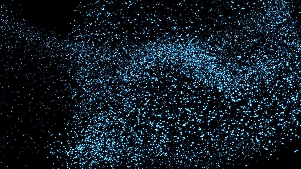 Abstract blue powder dust floating on a black background