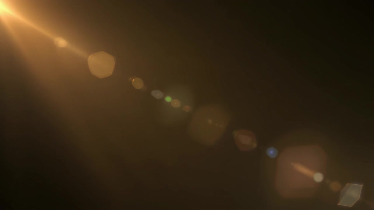 Gylden Lens Flare-effekt på sort baggrund