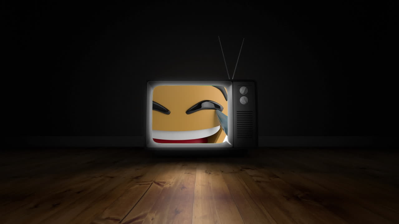 검은색 배경의 나무 표면에 텔레비전 화면에 웃는 얼굴 이모지 디지털 애니메이션