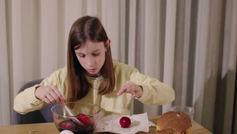 girl coloring easter eggs