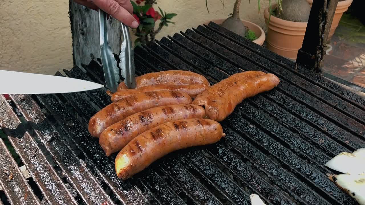 Taking sausage from grill