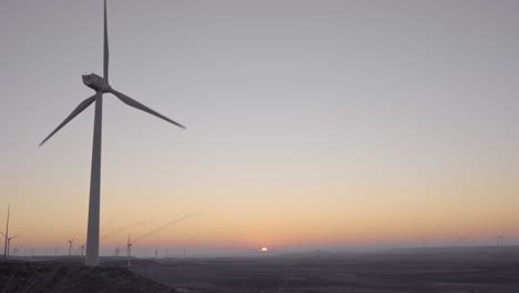 windmills in operation at sunrise