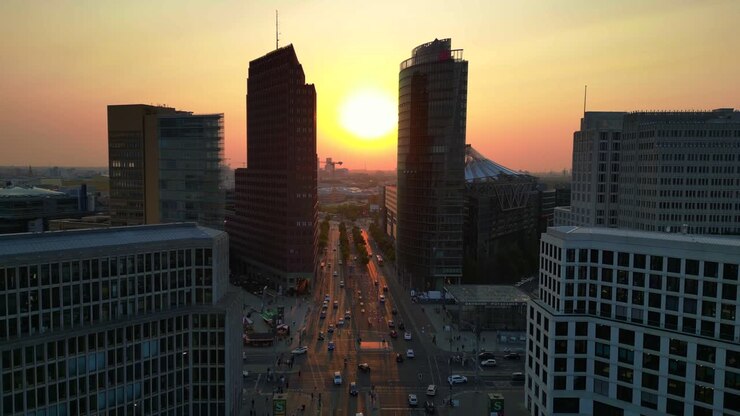 Berlin potsdamer platz skyline during golden hour sunset with traffic flowing on roads. Stunning aerial view flight panorama overview drone
