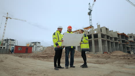 engineering group are viewing construction plan in modern building site professional builders