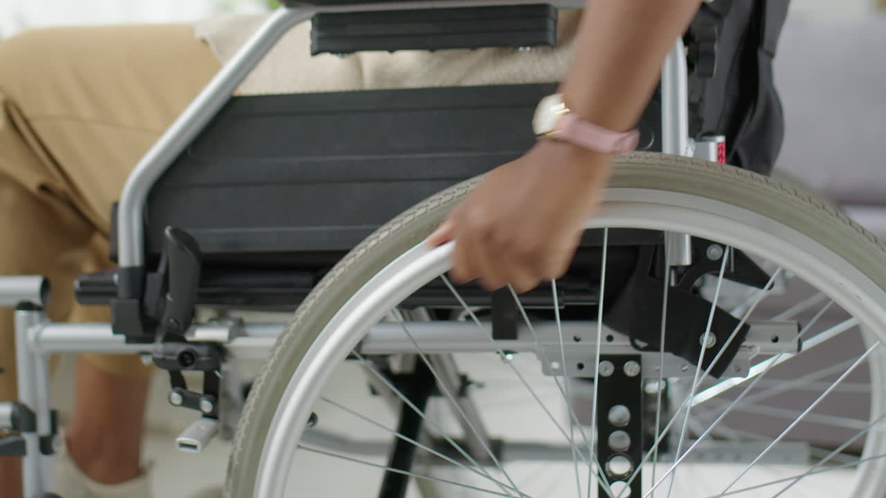 Woman Riding Manual Wheelchair at Home