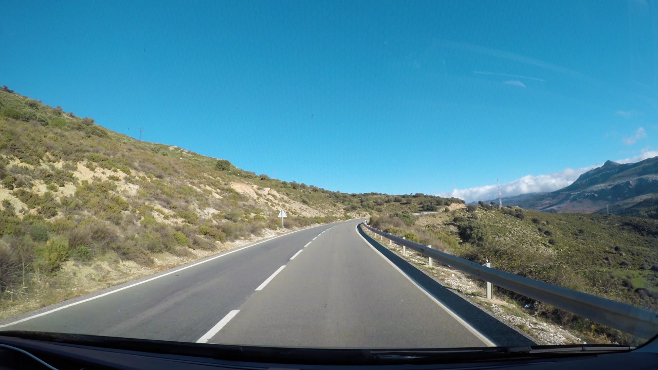 Winding road with panoramic mountain views in Spain, POV drive view