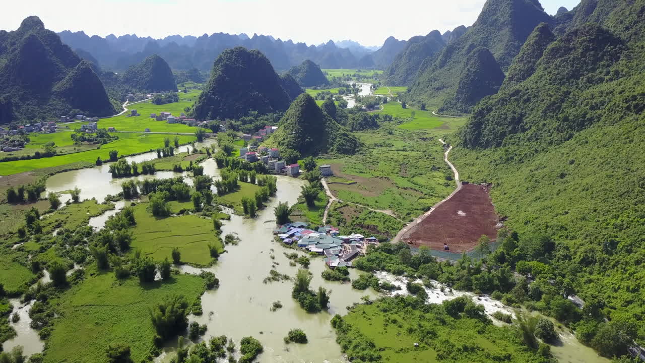 Aerial view of Ban Gioc Waterfalls in lush green mountain valley