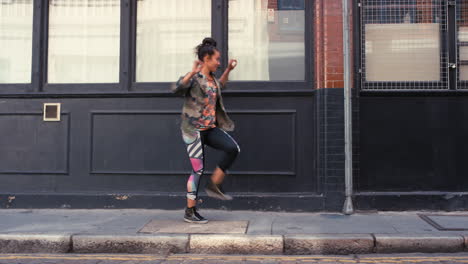 contemporary funky mixed race woman street dancer dancing freestyle in the city
