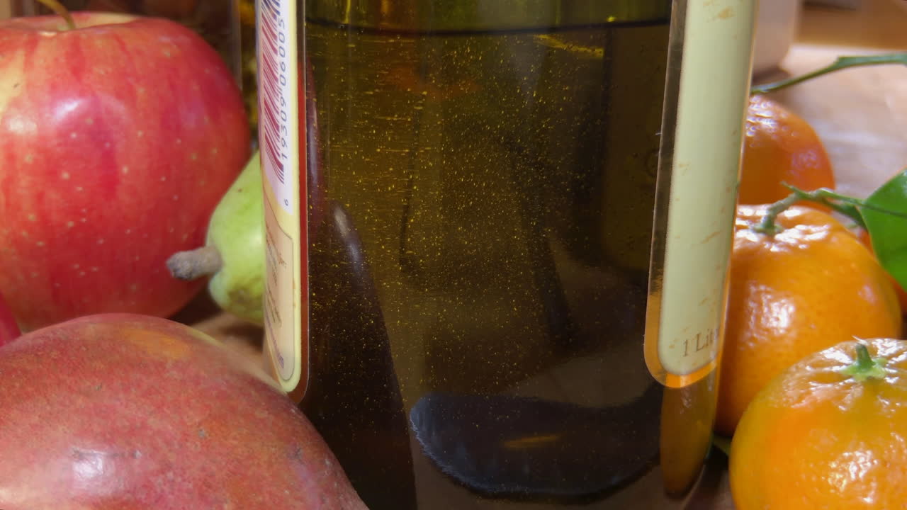 Close up of olive oil, air bubbles rising in bottle