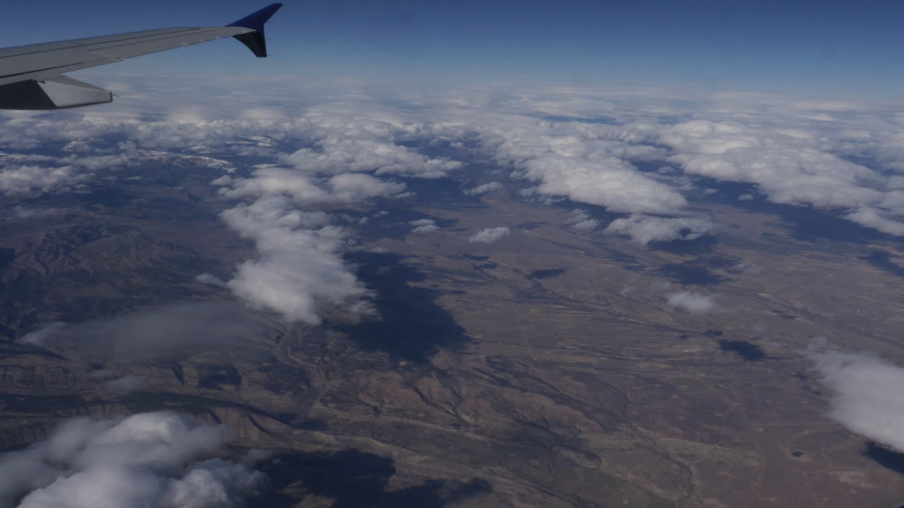 Aerial View of Mountainous Landscape from Airplane Window