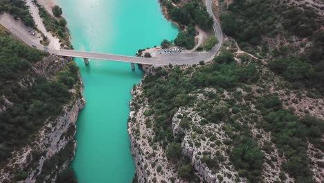 Forward-high-angle-drone-shot-of-a-bridge-connecting-the-end-of-a-gorge-in-France