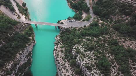 forward high angle drone shot of a bridge connecting the end of a gorge in france