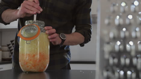 Homebrewing-organic-Kombucha-in-a-kitchen,-Inox-grater-in-foreground,-dolly-motion