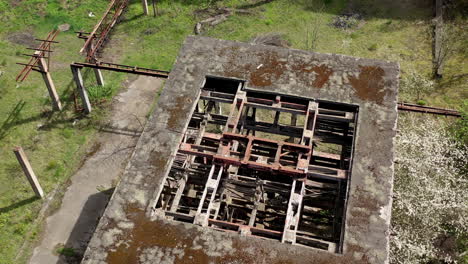 destroyed factory. abandoned ruined warehouse or production department on the factory territory. old industrial edifice without roof for demolition. aerial view.