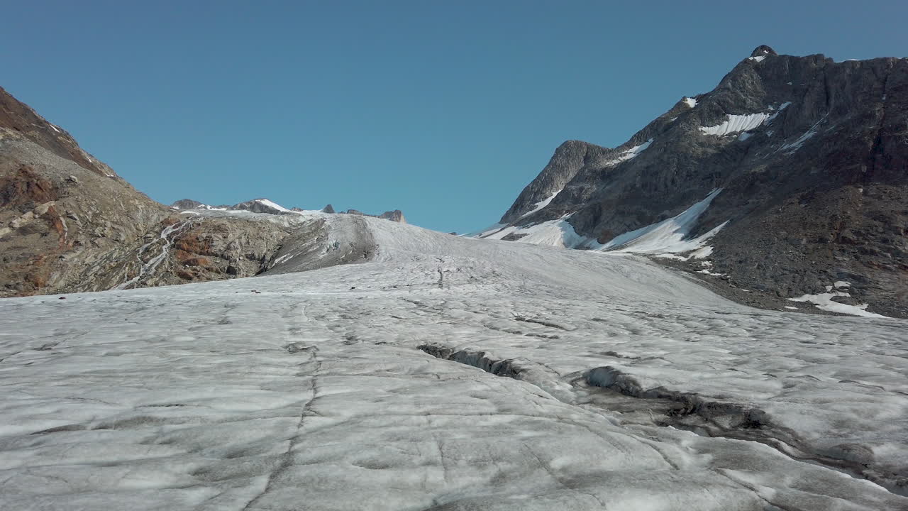 Low angle view looking up mountain slope over surface of glacier in Greenland