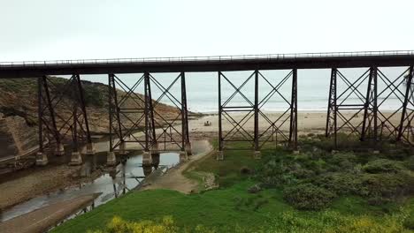 drone shot of ocean with high rise train tracks